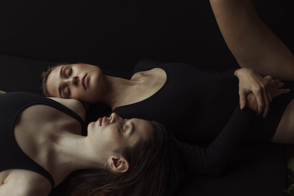 Group of pregnant women doing a gentle yoga pose in a studio setting